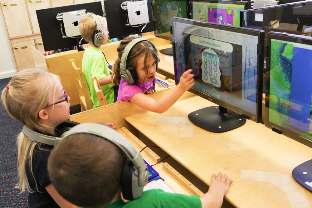 children working at a computer lab