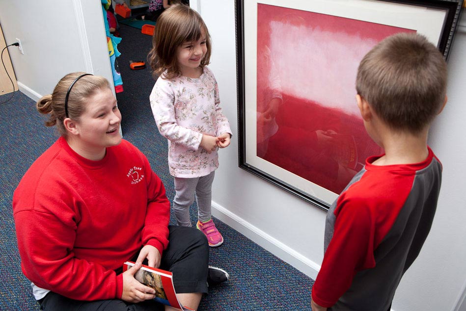 woman teaching kids about art