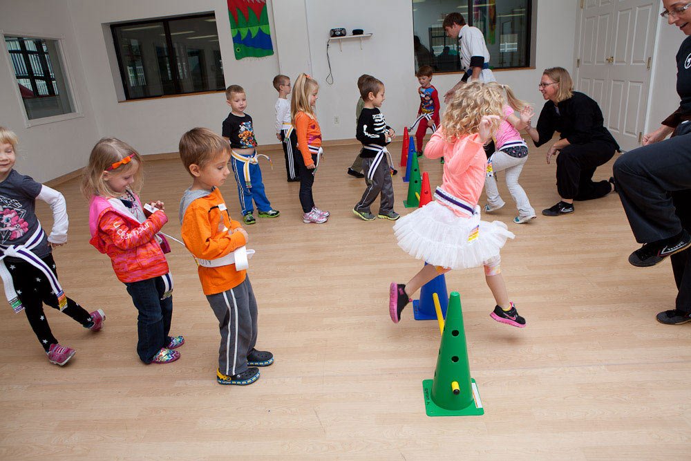 children practicing kung fu in a classroom setting