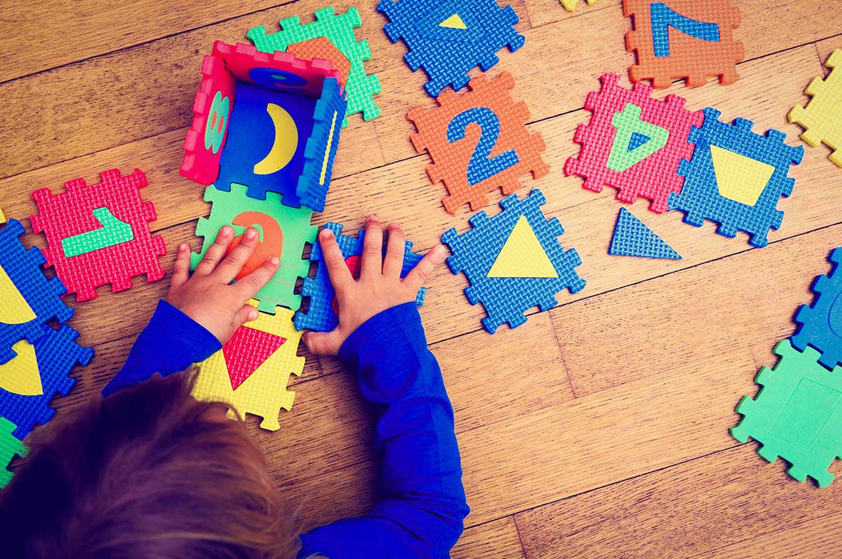 child playing with foam numbers