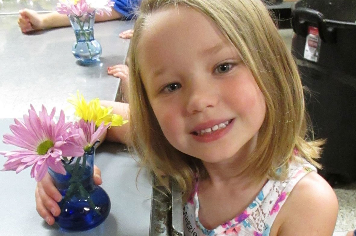 smiling girl holding flower