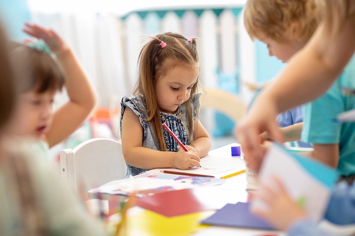 little girl coloring at preschool