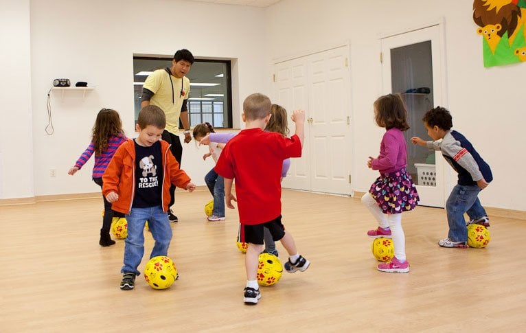 kids playing soccer in gym